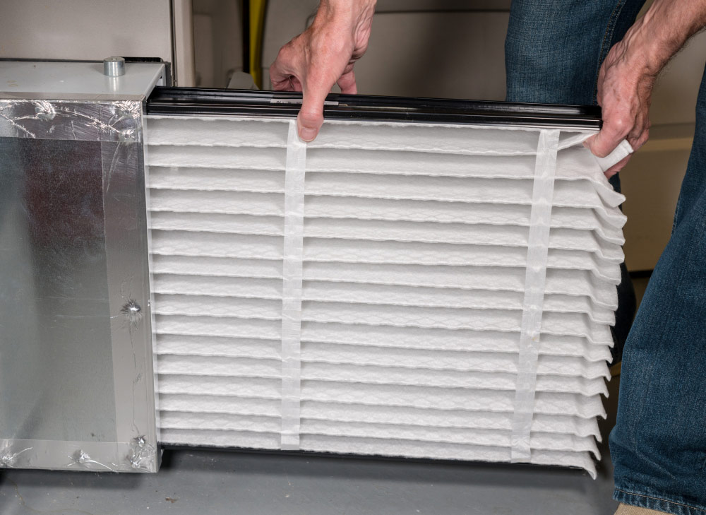 technician holding air filter