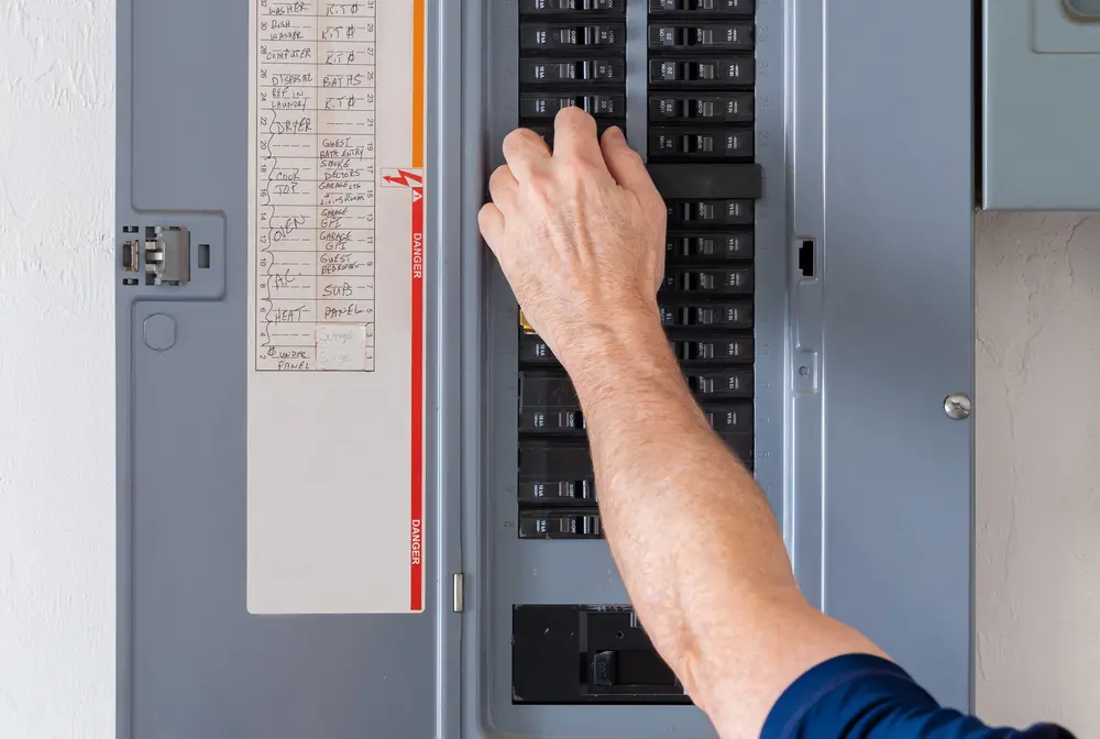Furnace Not Turning On? Here's Why - Charles Stone – Heating and Cooling Resetting tripped breaker in residential electricity power panel. Male electrician turning off power for electrical outlet at circuit breaker box.
