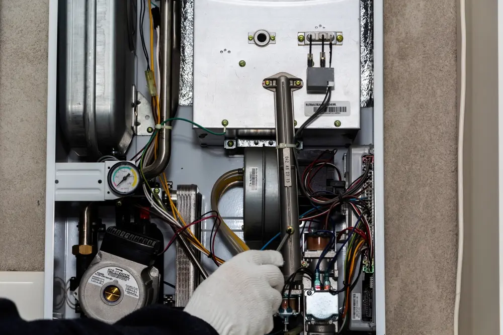 Furnace Not Turning On? Here's Why - Charles Stone – Heating and Cooling Heating Central Gas Furnace Issue. Technician Trying To Fix the Problem with the Residential Heating Equipment.
